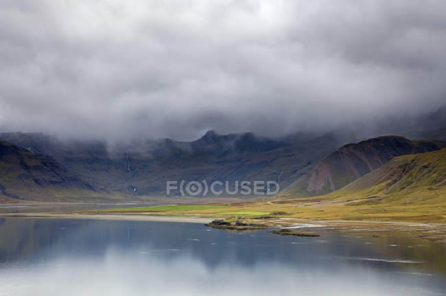 Wolken über abgelegener Landschaft und Wasser, Island — Stockfoto