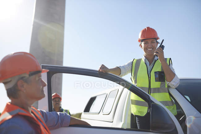 Portrait smiling, confident female engineer using walkie-talkie at truck — Stock Photo