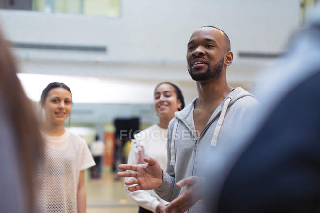 Male instructor leading discussion in dance class studio — Stock Photo