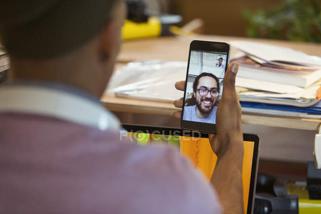 Empresário vídeo conversando com colega no telefone inteligente — Fotografia de Stock