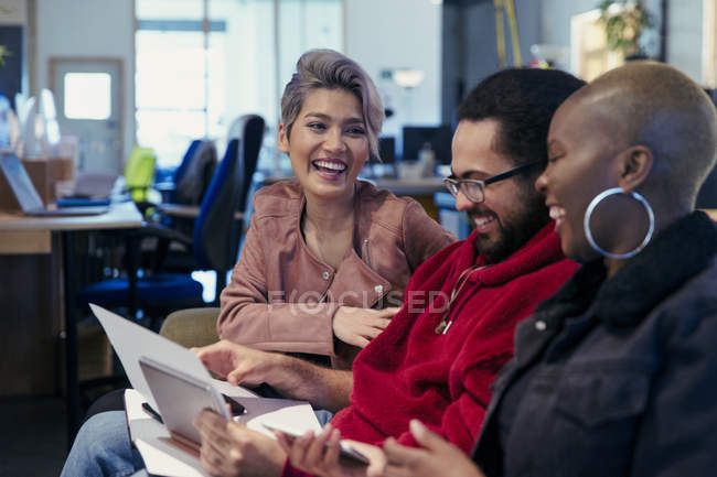 Laughing creative business people working in office — Stock Photo