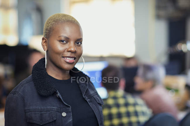 Portrait smiling, confident businesswoman, blurred background — Stock Photo