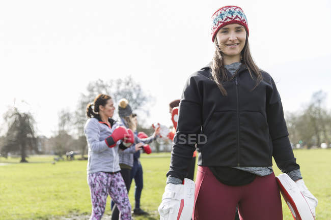 Portrait confident young woman boxing in park — Stock Photo