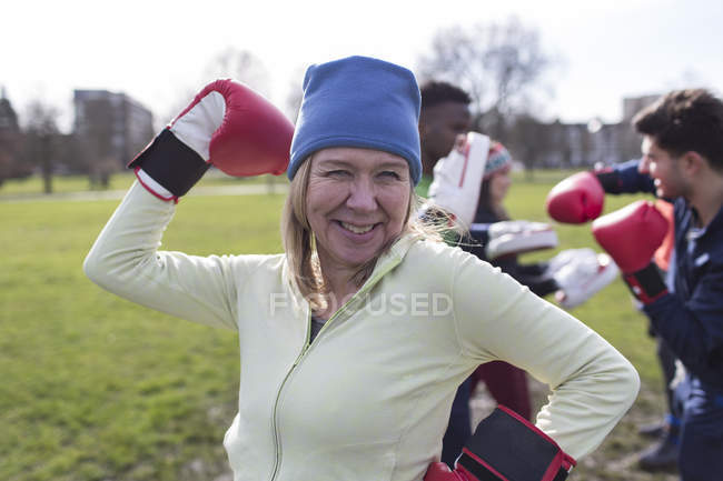 Porträt lächelnde, selbstbewusste Seniorin boxt im Park — Stockfoto