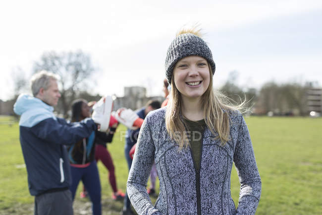 Portrait smiling, confident woman boxing with friends in park — Stock Photo
