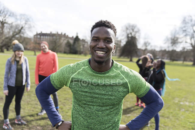 Retrato sorrindo, corredor masculino confiante no parque ensolarado — Fotografia de Stock