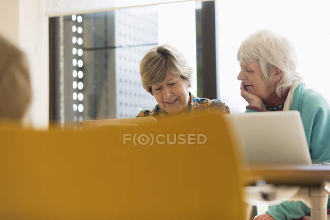 Senior businesswomen working at laptops in conference room meeting — Stock Photo