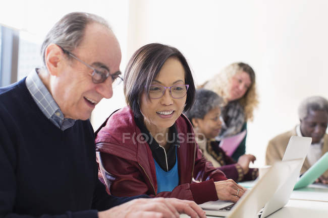 Senior business people using laptop in conference room meeting — Stock Photo