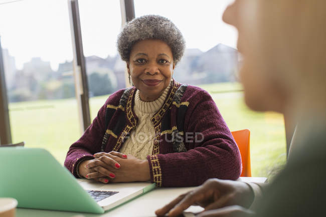 Портрет усміхнений, впевнена старша бізнес-леді використовує ноутбук у конференц-залі зустрічі — стокове фото