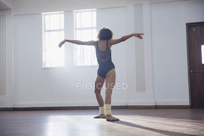 Витончена молода жінка танцює в танцювальній студії — стокове фото