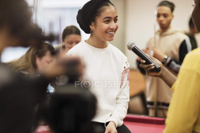 Smiling teenage girl being interviewed for vlog — Stock Photo