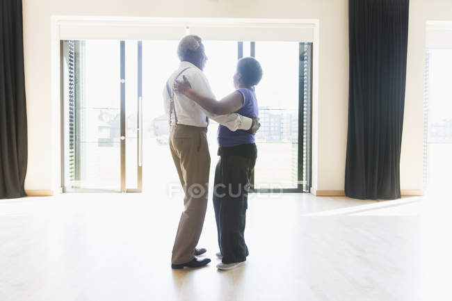 Active senior couple dancing in dance studio — Stock Photo