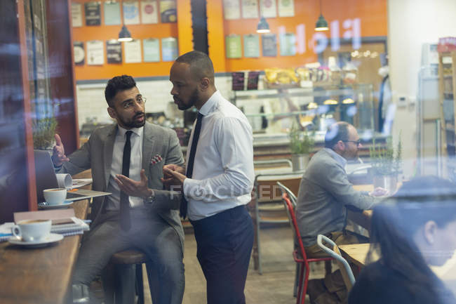 Businessmen using laptop, working in cafe — Stock Photo