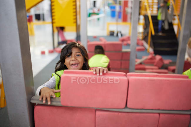 Portrait playful girl playing at construction exhibit in science center — Stock Photo