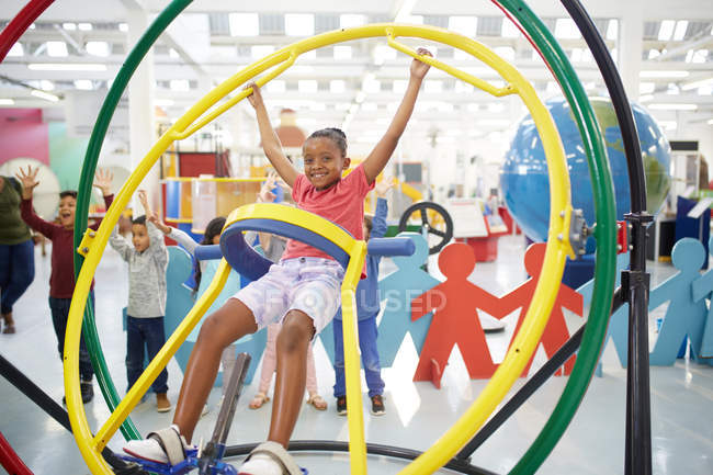 Portrait playful girl using gyroscope in science center — Stock Photo