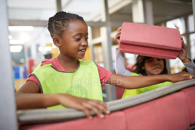 Girl playing with foam bricks at construction exhibit in science center — Stock Photo
