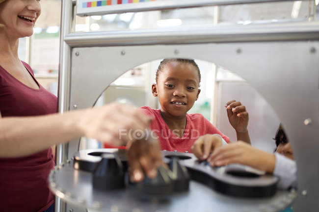 Curious girl playing at interactive exhibit in science center — Stock Photo