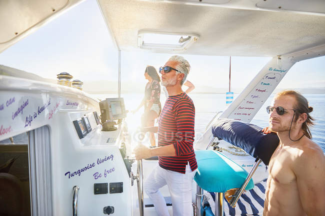 Man at helm on sunny boat — Stock Photo