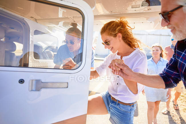 Friends boarding small airplane — Stock Photo