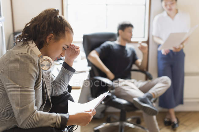 Focused creative businesswoman reading paperwork — Stock Photo