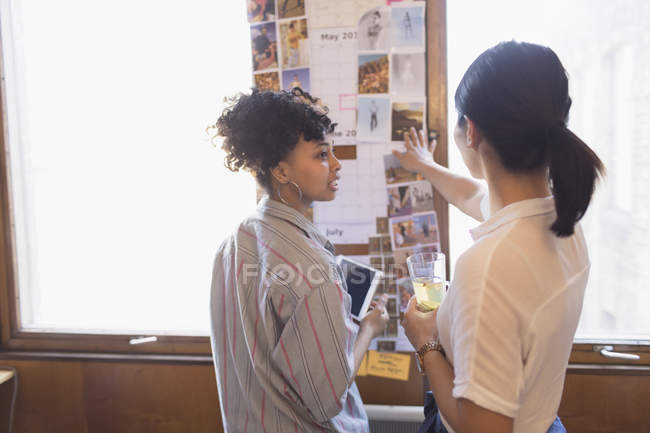 Creative female designers reviewing photographs — Stock Photo