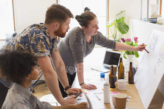 Creative designers discussing story board in office — Stock Photo