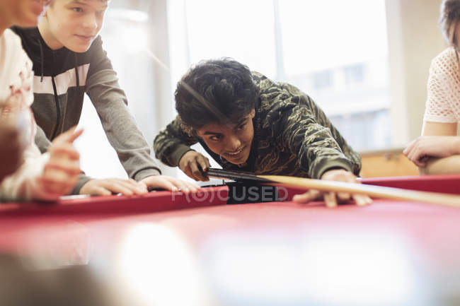 Adolescentes jugando al billar en interiores - foto de stock