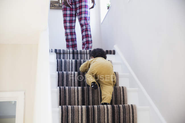 Baby boy crawling up stairs — Stock Photo