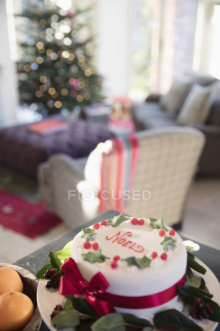 Decorated noel Christmas cake on sideboard in living room — Stock Photo
