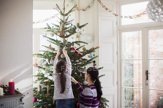 Mother and daughter decorating Christmas tree — Stock Photo