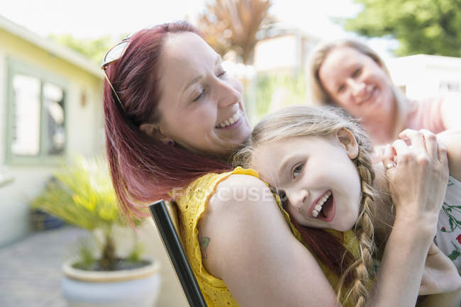 Affectionate mother and daughter on patio — Stock Photo