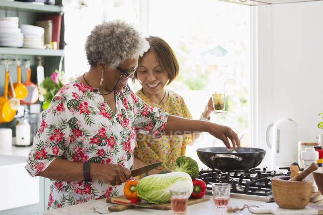 Active senior women cooking in kitchen — Stock Photo