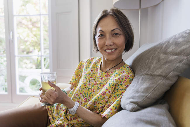 Porträt selbstbewusste Seniorin trinkt Tee im Wohnzimmer — Stockfoto