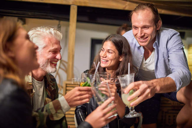 Friends toasting cocktails on patio — Stock Photo