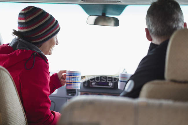 Couple drinking coffee in motor home — Stock Photo