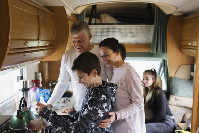Family cooking in motor home — Stock Photo