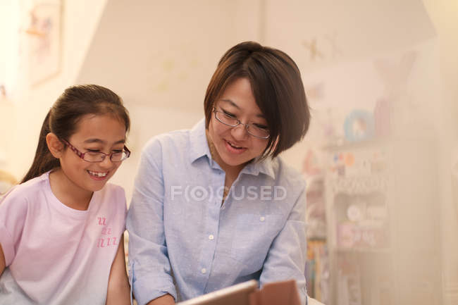 Mother and daughter using digital tablet — Stock Photo