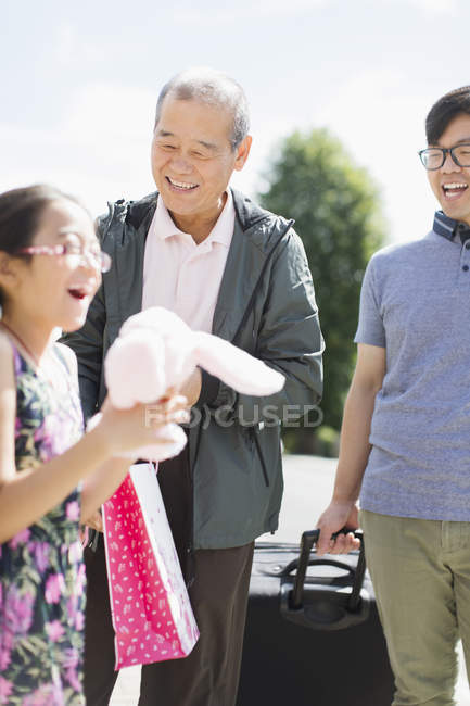 Grandfather visiting family outdoors — Stock Photo