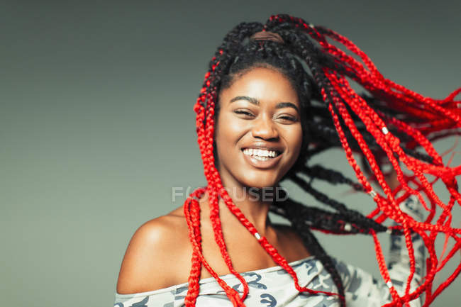 Portrait confident, carefree young woman with red braids — Stock Photo