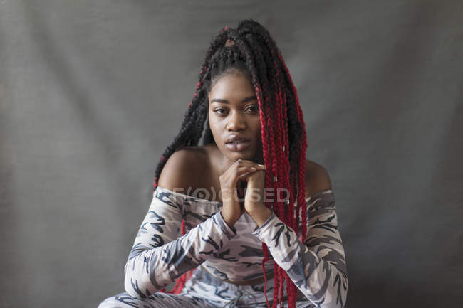 Portrait confident, cool young woman with red braids — Stock Photo