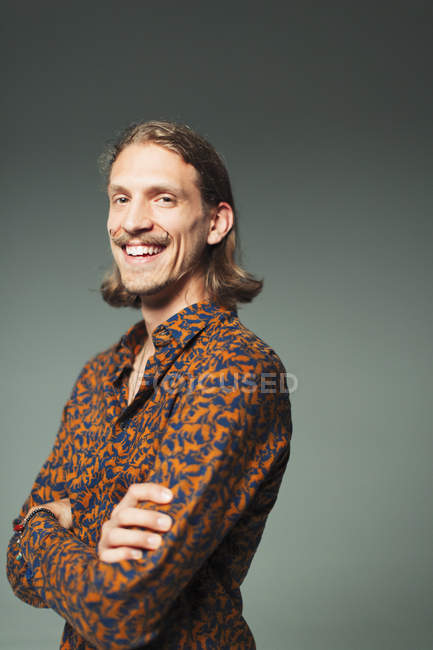 Portrait smiling, confident young man with handlebar mustache — Stock Photo