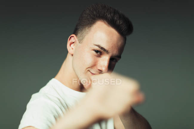 Portrait playful, cool teenage boy in fighting stance — Stock Photo
