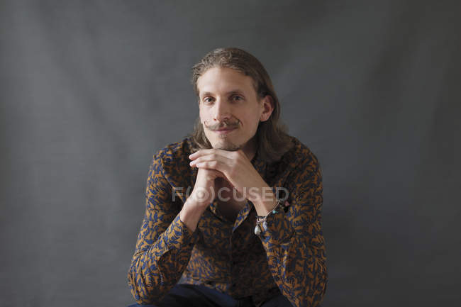 Portrait confident young man with handlebar mustache — Stock Photo