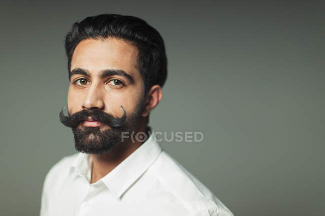 Portrait confident young man with handlebar mustache — Stock Photo