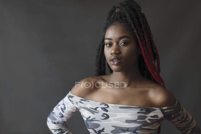 Portrait confident, cool young woman with braids — Stock Photo