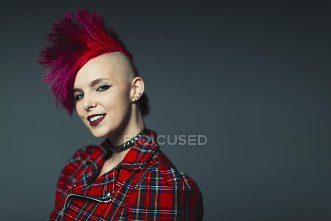 Portrait confident, cool young woman with pink mohawk — Stock Photo
