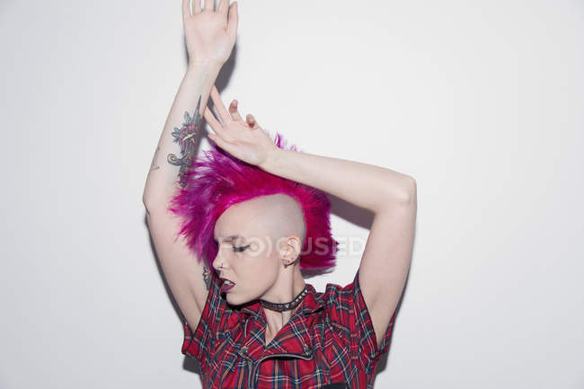 Portrait confident young woman with pink mohawk dancing — Stock Photo