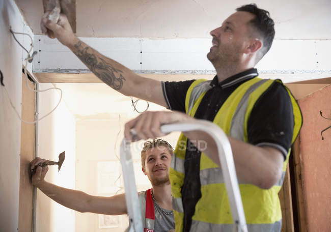 Construction workers plastering indoors — Stock Photo