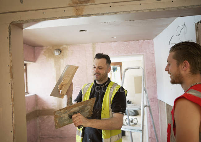 Construction workers plastering in house — Stock Photo