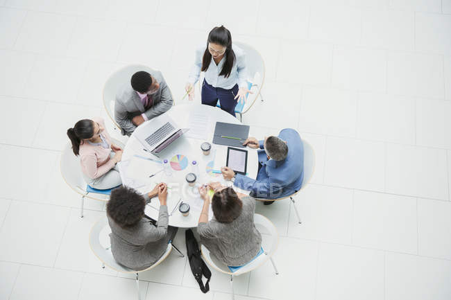 High angle view businesswoman leading meeting at round table — Stock Photo